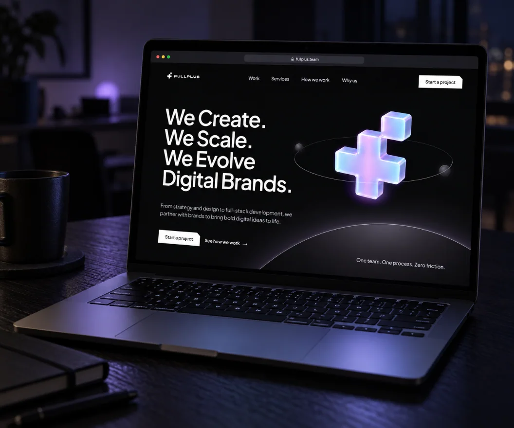 The fullplus.team landing page on a laptop in a dark studio at night: “We Create. We Scale. We Evolve Digital Brands.” in huge white type, a frosted iridescent glass plus floating in an orbit ring over a planet’s glowing horizon, and “One team. One process. Zero friction.”
